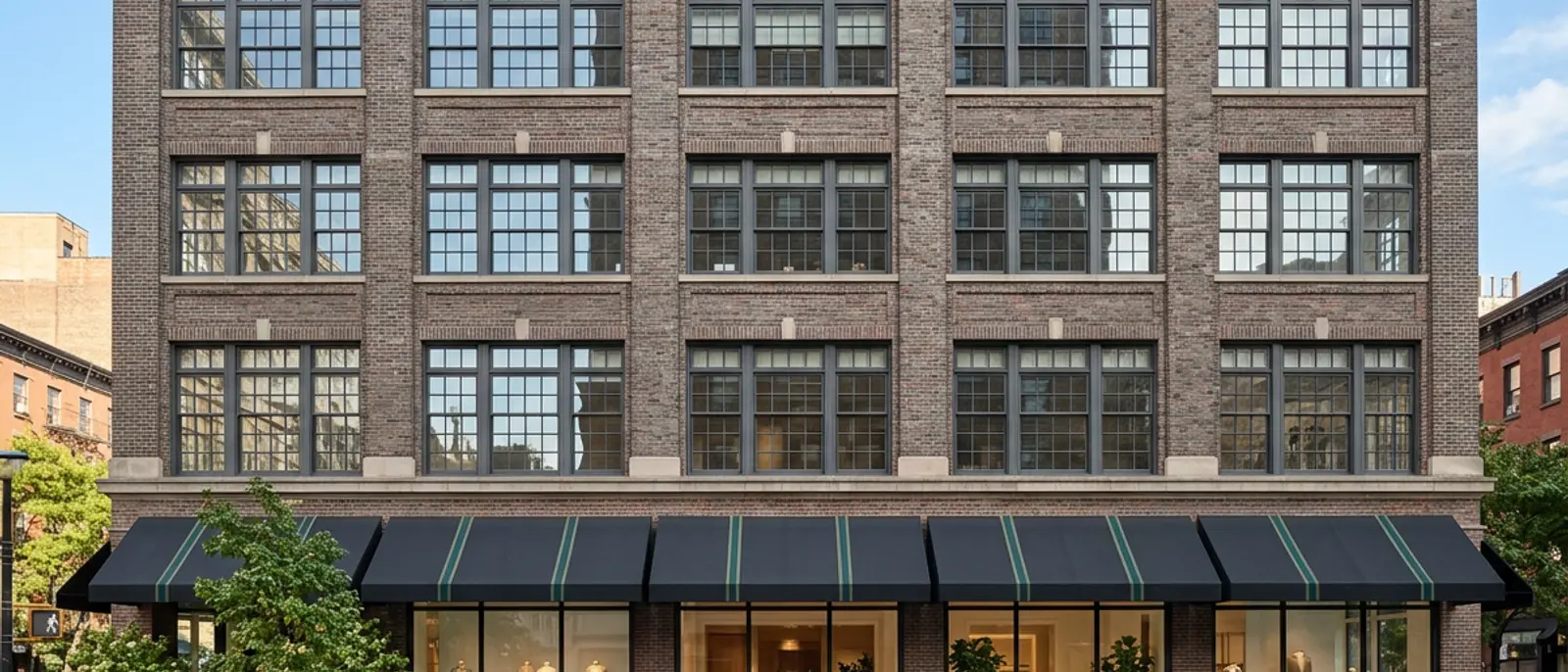 Brick commercial building in Manhattan with ground-floor plate-glass windows
